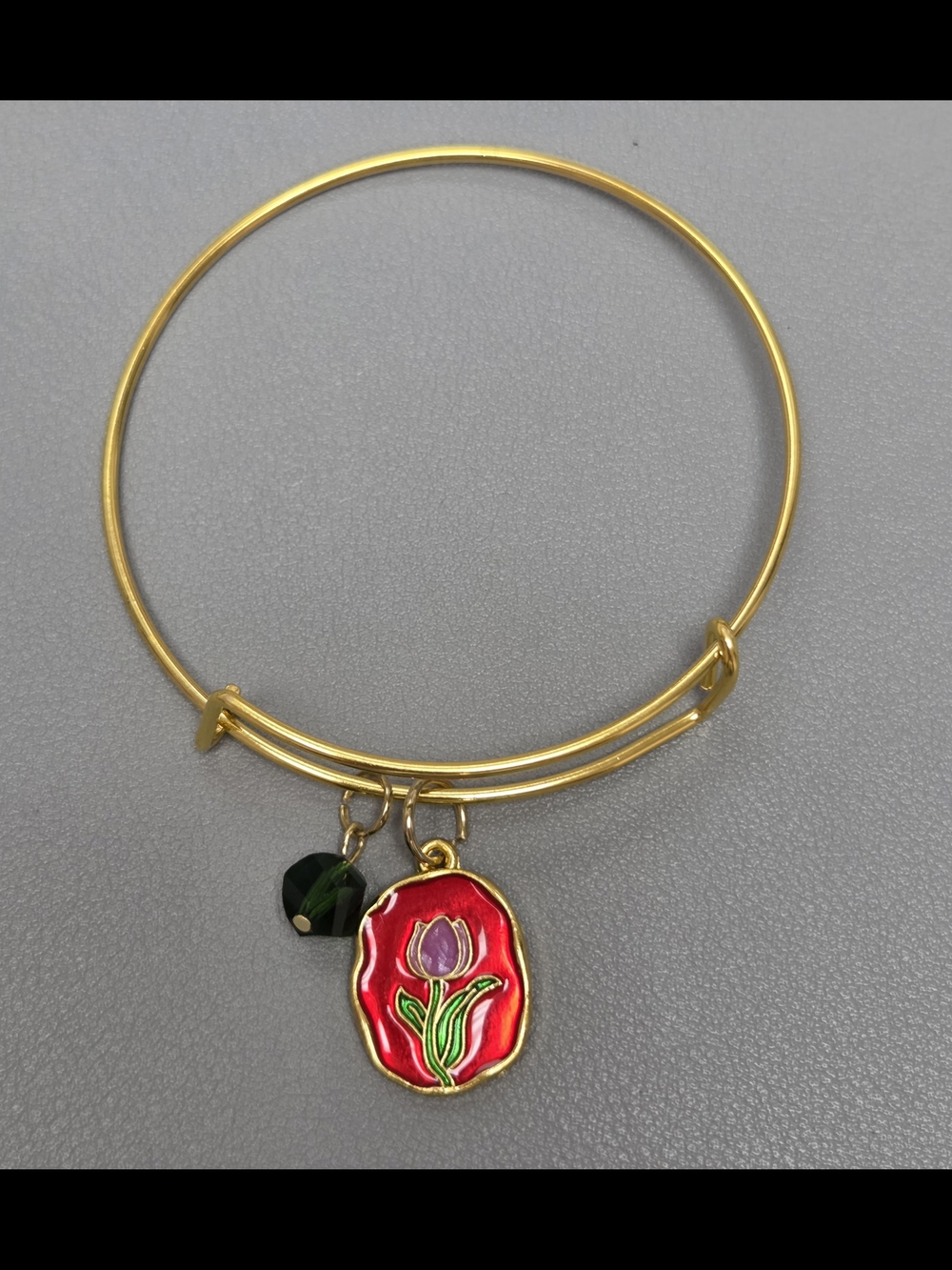 Gold Tone Bangle Bracelet with Pink Tulip Charm and Green Crystal